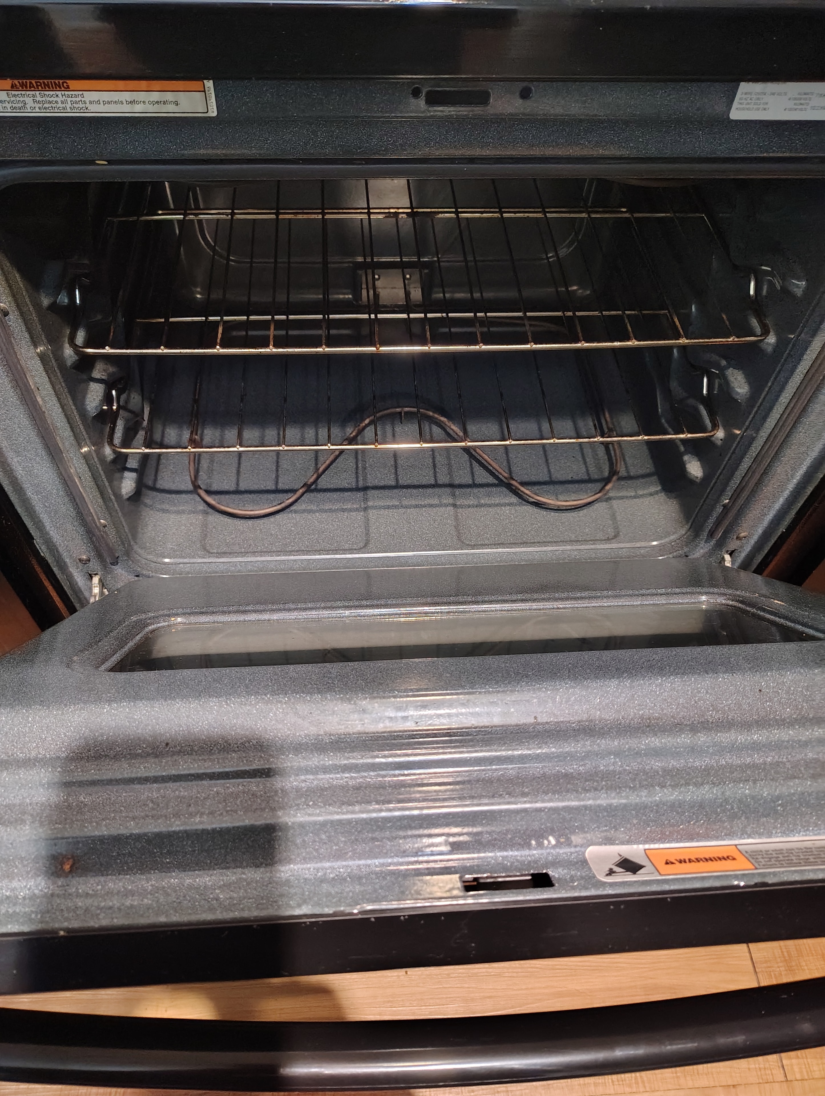 Twenty13 team member cleaning a refrigerator